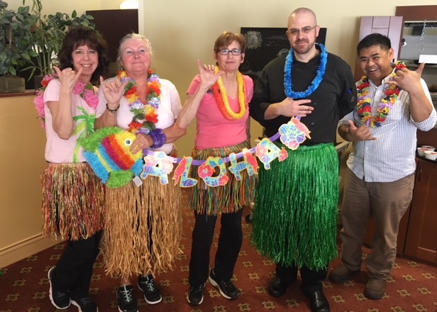 Team members dressed up for a Hawaiian luau. 